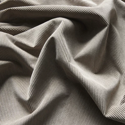 Närbild av textil i beige färg.