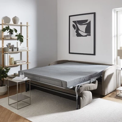 Utslagen bäddsoffa stående mot vägg