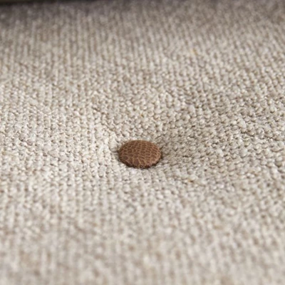 Närbild av vikmadrass med brunaktig knapp