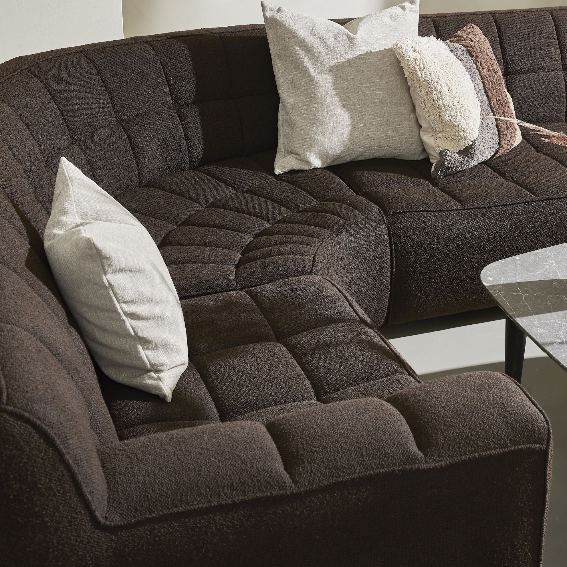 Brun rundad soffa med rutor.