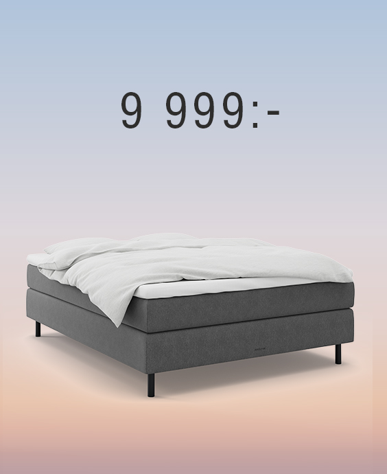 Grå kontinentalsäng mot regnbågsfärgad bakgrund