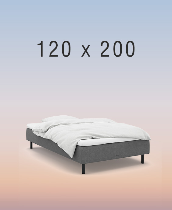 Grå boxmadrass på regnbågsfärgad bakgrund