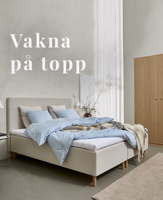 Ljusgrå resårbotten som dubbelsäng placerad i ett sovrum