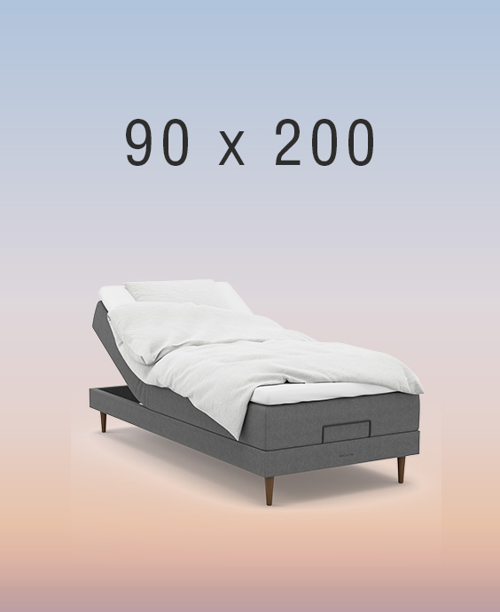 Grå ställbar säng på regnbågsfärgad bakgrund