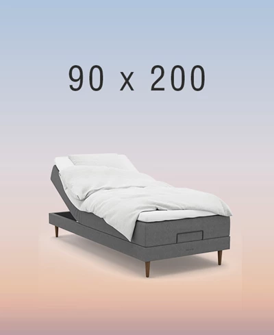 Grå ställbar säng på regnbågsfärgad bakgrund