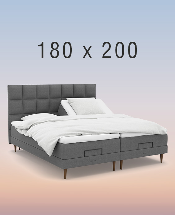 Grå ställbar säng på regnbågsfärgad bakgrund