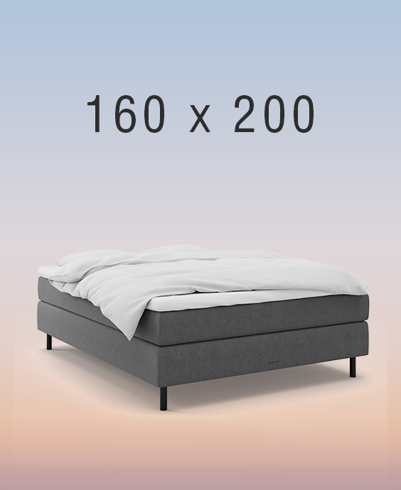 Grå kontinentalsäng på regnbågsfärgad bakgrund