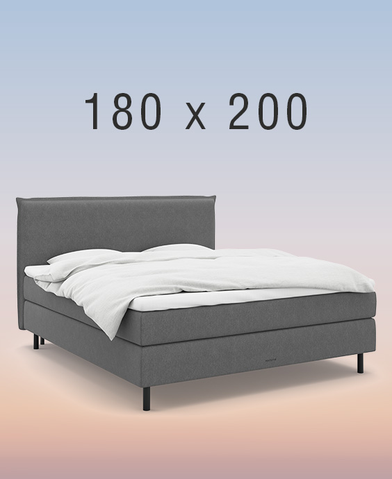 Grå kontinentalsäng på regnbågsfärgad bakgrund