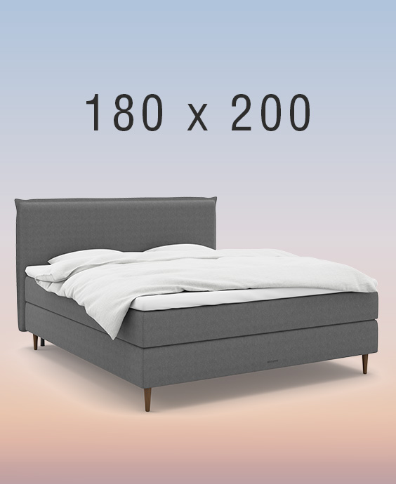 Ljusgrå kontinentalsäng i ett mysigt sovrum