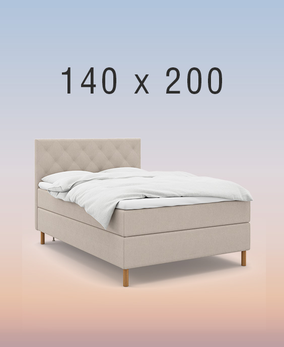 Ljusgrå kontinentalsäng i ett mysigt sovrum