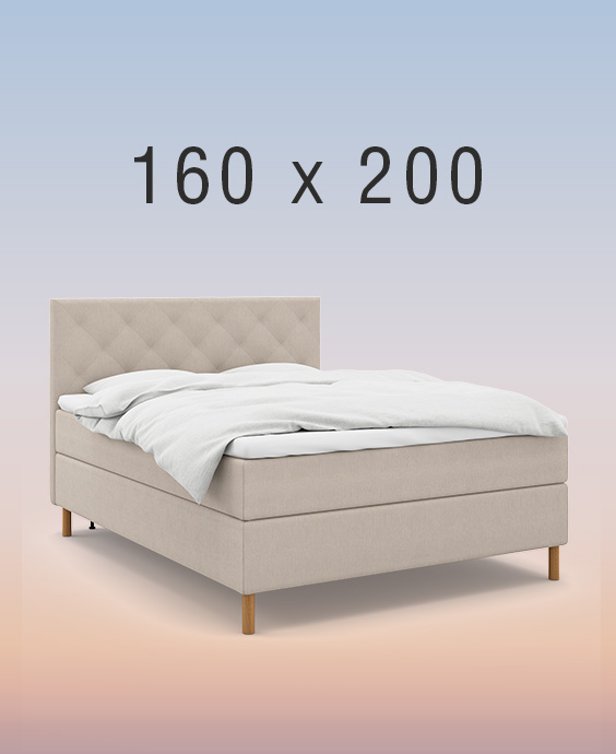 Ljusgrå kontinentalsäng i ett mysigt sovrum