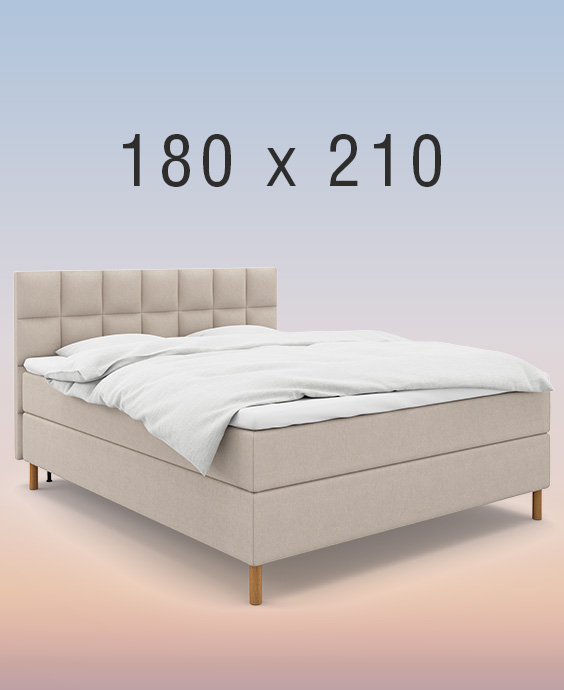 Ljusgrå kontinentalsäng i ett mysigt sovrum