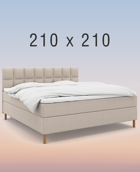 Ljusgrå kontinentalsäng i ett mysigt sovrum