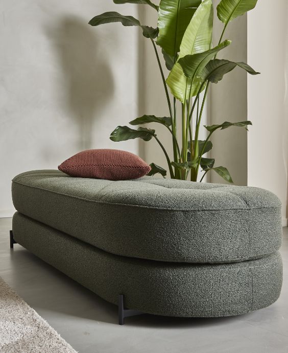 Grön, rund bäddsoffa i två lager