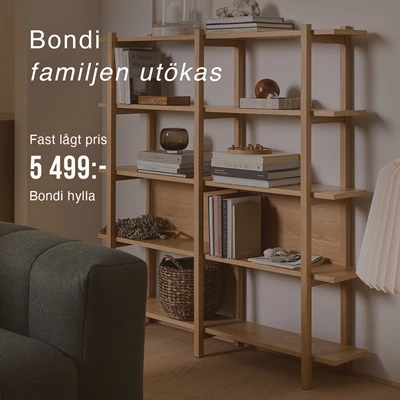 Trähylla placerad mot väggen med massor av inredningsdetaljer på.