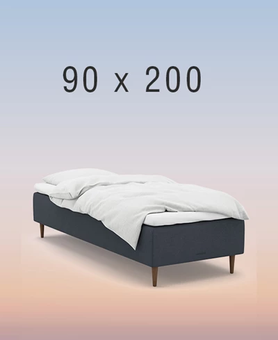 Ljusgrå ställbar säng på regnbågsfärgad bakgrund