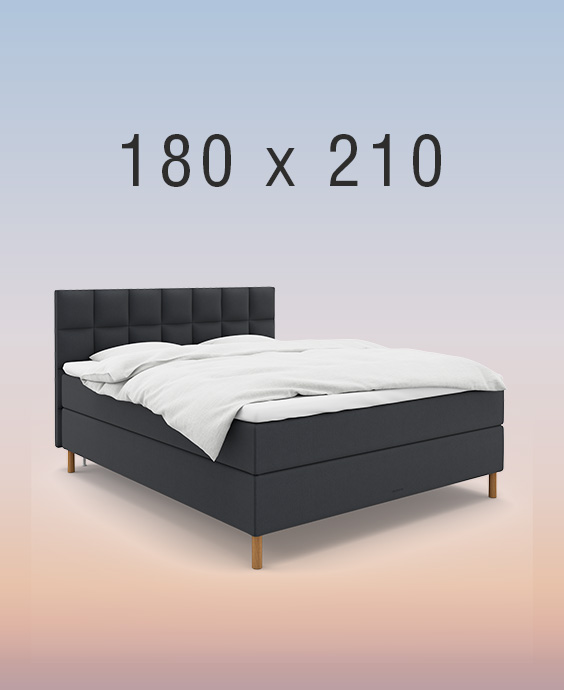 Ljusgrå kontinentalsäng i ett mysigt sovrum