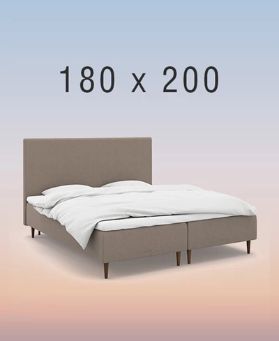 Grå ställbar säng på regnbågsfärgad bakgrund