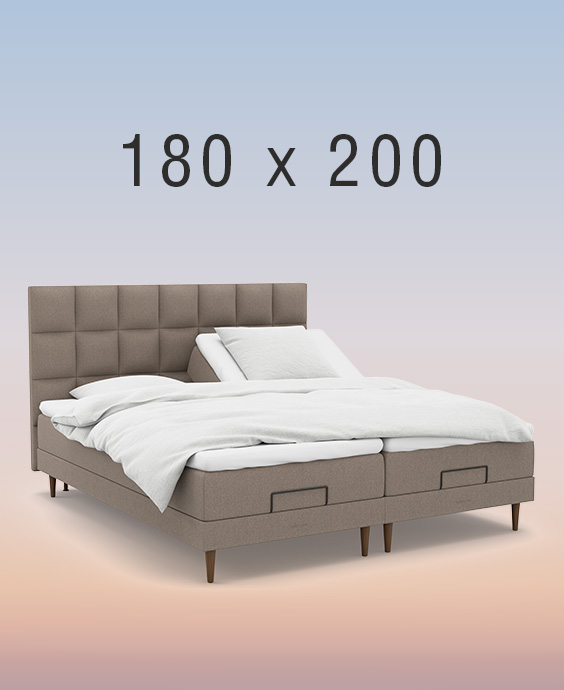 Grå ställbar säng på regnbågsfärgad bakgrund