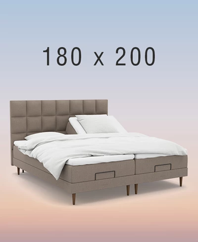 Grå ställbar säng på regnbågsfärgad bakgrund