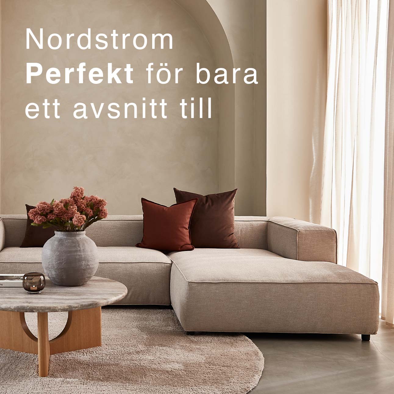 Djup soffa i beige i ett mysigt vardagsrum.