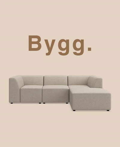 Grå modulsoffa mot beige bakgrund.