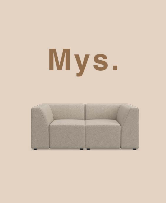 Grå modulsoffa mot beige bakgrund.