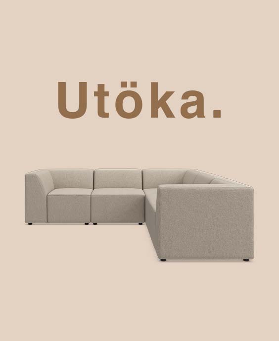Grå modulsoffa mot beige bakgrund.