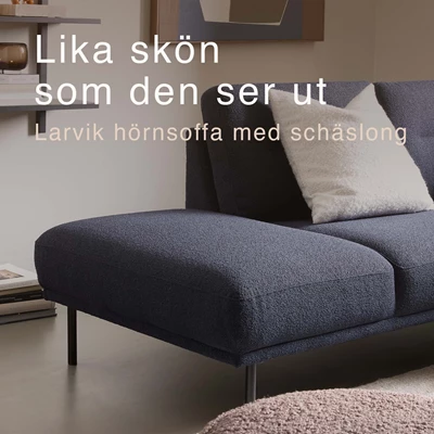 Blåaktig U-soffa i ett mysigt vardagsrum med svart soffbord.