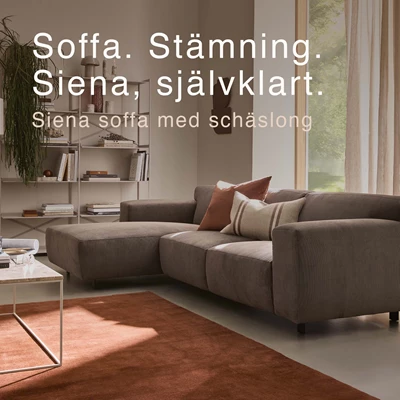Soffa med schäslong framför röd matta.